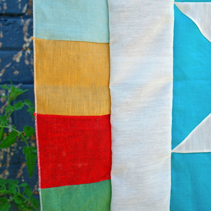 Colorful fabric with geometric patterns on a textured surface